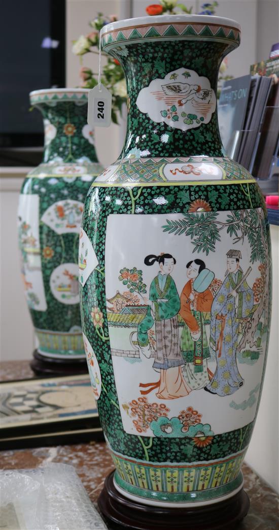 A pair of large Chinese porcelain vases with hardwood stands